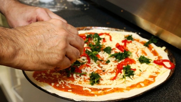 Amir preparing a pizza